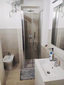 a bathroom with a shower and a sink and a toilet at Appartamento La Vela in Portoferraio