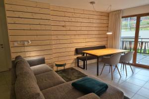 una sala de estar con un sofá y una mesa en Découvrez ce magnifique appartement au pied des pistes à La Féclaz, en La Féclaz