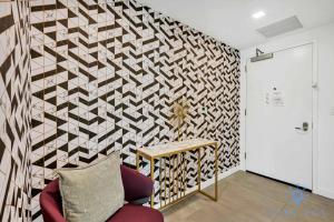 a living room with a wall with a geometric pattern at Beautiful Apartment with gym and amazing Pool in Miami +42 photos