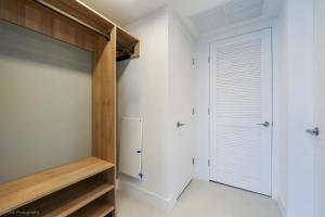 a bedroom with a closet and a refrigerator at New unit 28th Floor with Unbeatable Bayside Views in Miami +18 photos