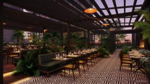 a restaurant with tables and chairs and plants at New unit 28th Floor with Unbeatable Bayside Views in Miami