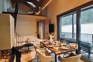 a living room with a table and chairs at ALOHA Suites - Alp LOdge HAus in Haus im Ennstal