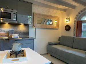 a living room with a couch and a kitchen at Huus Lüttenblick Whg Kajüte in Südstrand
