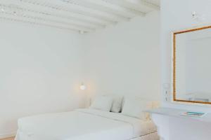 A bed or beds in a room at Aether Boutique Stay