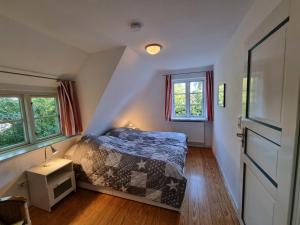 a bedroom with a bed in a attic at Friesentraum in Alkersum +4 photos