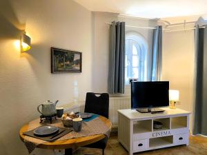 a living room with a table with a television on it at Huus Lüttenblick Whg Halligenblick in Wyk auf Föhr