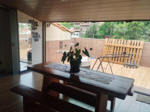 a table with a potted plant on top of it at Casa de maurinho in Ouro Preto +3 photos