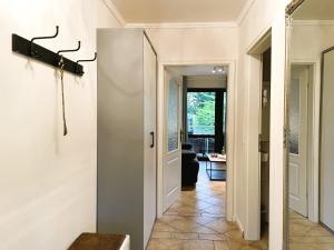 a hallway with a door leading to a living room at Fischerhuus Whg 3 in Wyk auf Föhr +14 photos