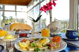 a table with a plate of food on a table at Rowanville Lodge in Grange