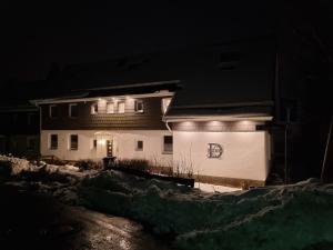 a house with lights on the side of it at night at Haus Ilse Wohnung 9 in Sankt Andreasberg