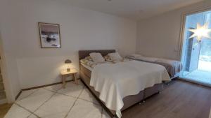 a bedroom with two beds and a window at Villa Tervas, Arctic circle in Rovaniemi