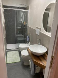 a bathroom with a toilet and a sink and a shower at Emozioni al Lago in Farra dʼAlpago