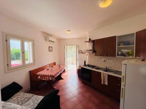 a kitchen with a table in the middle of it at Casa Solana al Cavo - Elba Affitti in Cavo