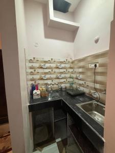 a kitchen with a sink and a counter top at Vindh Homestay in Varanasi