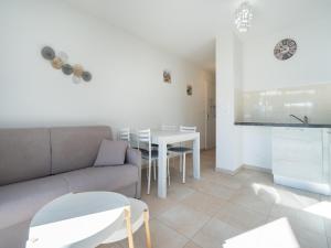 a living room with a couch and a table at La Dune 32 - Villa 2P4 in Sérignan