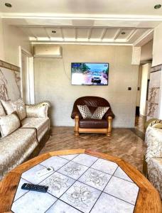 a living room with a couch and a chair at Hola bonjour corniche nador in Nador