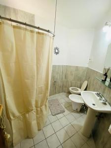 a bathroom with a shower and a toilet and a sink at San Roque in San Roque +6 photos
