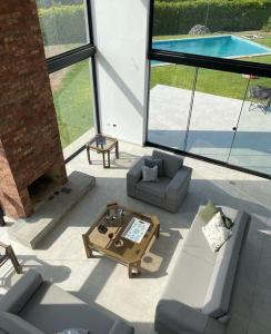 a living room with couches and a table and a pool at Casa Tullpa in Aspitia +11 photos
