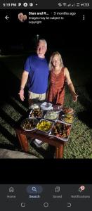a man and woman standing in front of a table of food at QUEEN ELIZABETH CULTURE CENTRE kasese in Kasese