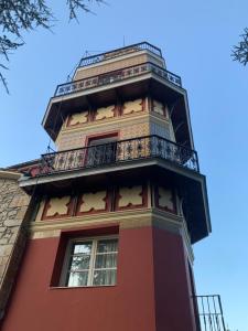 a tall red building with stars on it at Posada Giraldilla in Liérganes