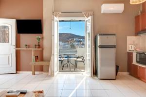 a kitchen with a door open to a patio with a table at Marbil Irida Kythnos in Mérikhas