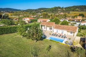 an aerial view of a house with a swimming pool at Villa Loupia by Villa Plus in Loupia