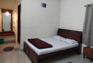 Postel nebo postele na pokoji v ubytování Prashanth Family Homestay