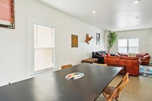 a living room with a table and a couch at 4BR Gem in Detroit North End Downtown Nearby in Detroit