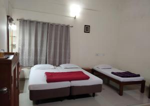 Postel nebo postele na pokoji v ubytování Prashanth Family Homestay