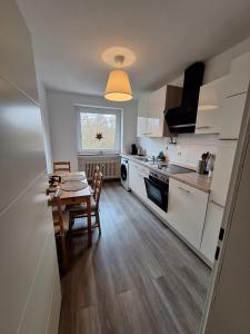 a kitchen with a table and a dining room at Elpke in Bielefeld