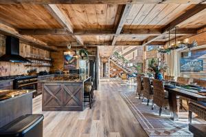 a kitchen with wooden ceilings and wooden tables and chairs at Alpine Haven Cabin and Spa in Gatlinburg