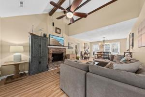 a living room with a couch and a fireplace at 515 Tarpon Pond Cottage in Seabrook Island