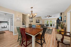 a dining room and living room with a table and chairs at 515 Tarpon Pond Cottage in Seabrook Island