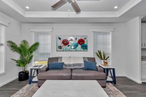 a living room with a couch and two tables at Pony Flat in Ocala