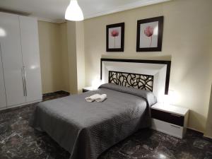 a bedroom with a bed with a stuffed animal on it at Pablo de Olavide, Despeñaperros in La Carolina +12 photos