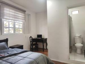 Postel nebo postele na pokoji v ubytování Hotel Muros Quito