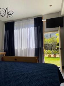 a bedroom with a bed and a large window at Habitacion privada Lamat I in San Pedro La Laguna