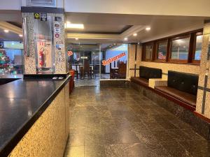 a bar in a restaurant with a counter and chairs at HOTEL CENTRAL - Belem in Belém