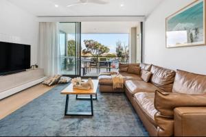 un soggiorno con divano marrone e TV di Parkvue 11 What a Spot a Mornington