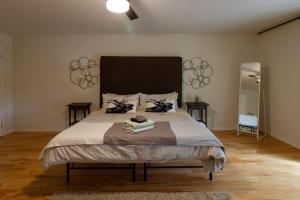 a bedroom with a large bed with a large headboard at Vineyard Suite - Family Friendly in Picton PEC in Picton