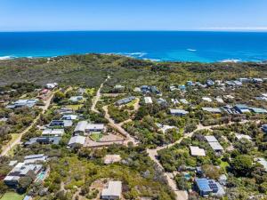an aerial view of a group of houses in front of the ocean at LUXE POINT in Blairgowrie