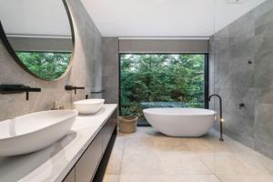 a bathroom with two sinks and a large mirror at VILLA BOND Mount Eliza-Incredible in every sense. in Mount Eliza +14 photos