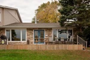 a house with a deck with a table and chairs at Vineyard & Craft House - Rare 6 bedroom Gem in Picton in Picton