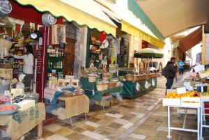 Un mercado con gente caminando frente a una tienda. en VILLA VIIEUX MOULIN Villa avec piscine pour 7 personnes avec piscine à Hyères, en Hyères 19 fotos más