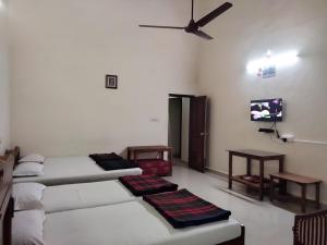 Postel nebo postele na pokoji v ubytování Prashanth Family Homestay