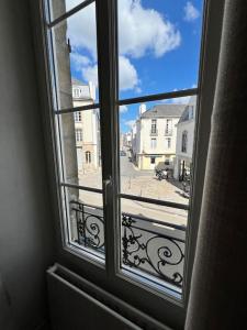 an open window with a view of a street at Saint Goustan à pied! Joli appartement 2p in Auray