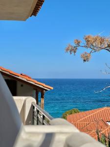 a view of the ocean from the balcony of a house at Marinos Studios and Apartments in Gialiskari