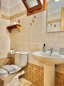 a bathroom with a toilet and a sink at Marinos Studios and Apartments in Gialiskari