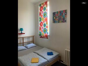 sypialnia z 2 łóżkami pojedynczymi i oknem w obiekcie Hostel Praha Ládví w Pradze