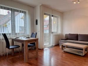 a living room with a table and a couch at Ferienwohnung Kleine Seeperle - Ihr Rückzugsort in Nonnenhorn in Nonnenhorn